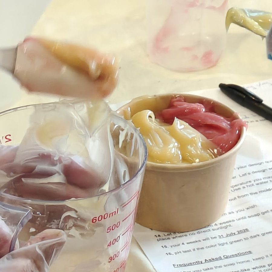 Spooning soap batter into a cup